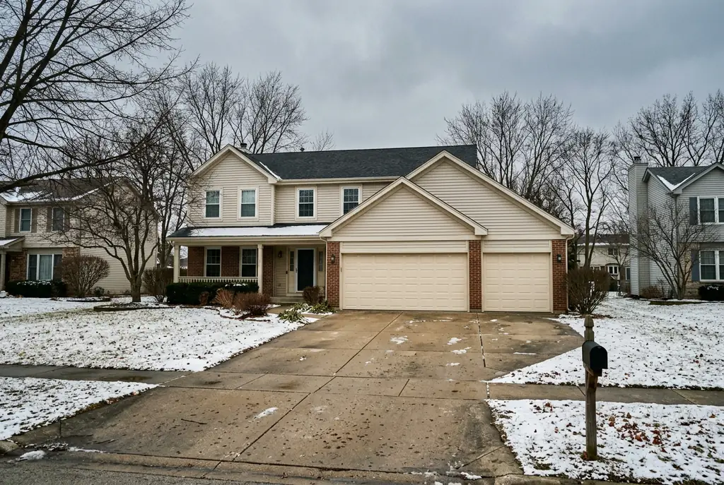 Garage door service in the northwest suburbs — a three-car attached garage on a suburban home with raised-panel steel doors.